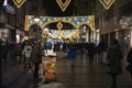 BELGRADE, SERBIA - JANUARY 7, 2023: Selective blur on a man selling corn at night on Kneza Mihailova street with shops in old town