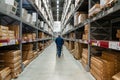 Belgrade, Serbia - January 02, 2023: Warehouse aisle in an IKEA store. Man walking i IKEA furniture warehouse area