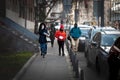 Selective blur on three young adults, men and women, friends, walking in winter Royalty Free Stock Photo