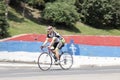 Mature man in cycling jersey outfit riding bike on city street