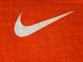 Nike white logo on cardboard orange sneakers box.