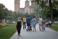 BELGRADE, SERBIA - JULY 22, 2020: Old people, a man and a woman walking in the middle of a crowd in a park of Belgrade