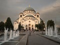 Selective blur on Saint Sava Cathedral Temple (Hram Svetog Save) with crowd of serbs walking in