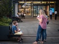 Selective blur on a family, boys, kids, children and their mother, eating all Italian ice cream and frozen yogurt in summer