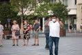 Indian tourist, middle aged man from india, touching and adjusting his facemask to remove it in Belgrade streets while travelling