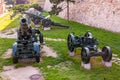 Artillery guns and weapons stand on stone foundations as part of outdoor exposition of various artillery weapons on territory of Royalty Free Stock Photo