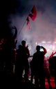 Young football fans watching football match on the street screen