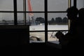 Silhouetts of passengers waiting at airport Royalty Free Stock Photo