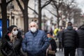 Selective blur on happy smiling Old senior man and woman, couple, wearing a facemask, waking in street of Belgrade during covid Royalty Free Stock Photo