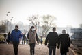 Selective blur on a man and a woman, couple, wearing a face mask, waking in a street of Belgrade in winter, during covid 19