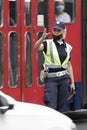 Policewoman standing in the intersection directing the traffic