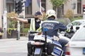 Traffic policewoman and motor policeman on duty, standing in the intersection