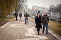 Selective blur on two young adults, men, friends, walking in winter, some wearing a respiratory face mask in streets of Pancevo Royalty Free Stock Photo