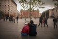 BELGRADE, SERBIA - NOVEMBER 3, 2021: Selective blur on a couple of lovers sitting in front of Trg Republike square & National