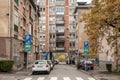 Selective blur on lines of cars parked in the city center of Belgrade, with roadsigns indicating parking lot on residential street