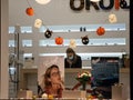 Woman, staff emplyee worker wearing a respiratory face mask in an optician store in Belgrade,