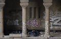 Group of young male refugees waking up under the city street downtown bridge