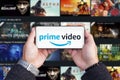 Belgrade, Serbia - October 05, 2022: Holding smartphone in hands with Amazon Prime video logo on screen Royalty Free Stock Photo