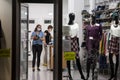 Two store workers of a fashion retailer clothing shop wearing a respiratory face mask in Belgrade,