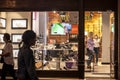 Clients and female staff of a footwear shoes shop wearing a respiratory face mask in Belgrade