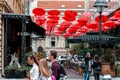 Belgrade, Serbia - September 27, 2019: Cozy outdoor cafe decorated with red umbrellas at Kralja Petra street