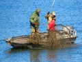 The fishermen on the boat collecting net on Sava river.