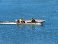 The fishermen on the boat collecting net on Sava river.