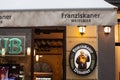 Franziskaner Weissbier logo in front of the terrace of a Serbian bar.