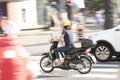 One woman riding a vespa scooter in the city street traffic