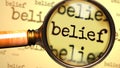 Belief and a magnifying glass on English word Belief to symbolize studying, examining or searching for an explanation and answers