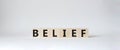 Belief symbol. Concept word Belief on wooden cubes. Beautiful white background. Business and Belief concept. Copy space