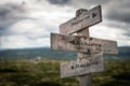 Believe, achieve and recieve text on wooden rustic signpost outdoors in nature/mountain scenery Royalty Free Stock Photo