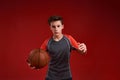 Believe and Achieve. A teenage boy is engaged in sport, he is looking at camera while holding basketball. Isolated on Royalty Free Stock Photo