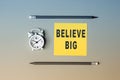 Believe BIG - text on sticky note paper. Closeup of a personal agenda. Top view