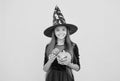 Believe in the Magic. teenage child in witch hat. cheerful kid holding pumpkin. carnival costume party. trick or treat