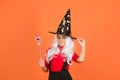 Believe in miracles. happy halloween. smiling child in witch hat. kid hold magic wand. childhood happiness. girl ready