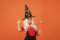 believe in miracles. happy halloween. smiling child in witch hat. kid hold magic wand. childhood happiness. girl ready