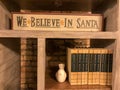 We believe in Santa wooden sign on bookcase Royalty Free Stock Photo