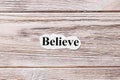 Believe of the word on paper. concept. Words of believe on a wooden background