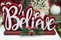 Believe word wooden Christmas decoration. Inspirational word BELIEVE with christmas decor Royalty Free Stock Photo