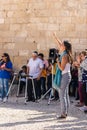 Believer lifts her hands to heaven during group prayer in the courtyard of the Chapel of the Ascension on Mount Eleon - Mount of