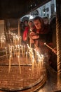 Believers light candles at the candlelight spot in the side hall of the Church of Nativity in Bethlehem in the Palestinian Royalty Free Stock Photo