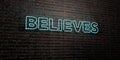BELIEVES -Realistic Neon Sign on Brick Wall background - 3D rendered royalty free stock image