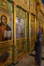A believing Christian woman looking at icons in the monastery of St. John the Baptist in Christian quarters in the old city of