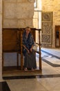 A believing Christian woman sits in the monastery of St. John the Baptist in Christian quarters in the old city of Jerusalem,