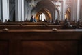 Believing woman sits on a bench in the church and prays to God with hands clasped Royalty Free Stock Photo