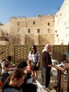 The believing women read religious books before the Wailing Wall