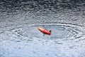 BELIS-FANTANELE, ROMANIA, AUGUST 12, 2023: Man trying to climb into the overturned kayak on Belis-Fantanele dam lake.