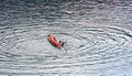 BELIS-FANTANELE, ROMANIA, AUGUST 12, 2023: Man trying to climb into the overturned kayak on Belis-Fantanele dam lake.