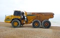 Articulated dump truck. The Bell B40D on pebbled beach.